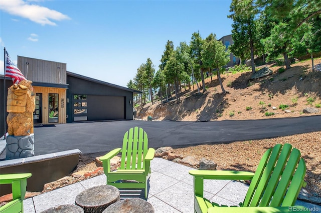 555 Sunrise Peak Rd, Manitou Springs, CO 80829 - view of patio with driveway and a garage