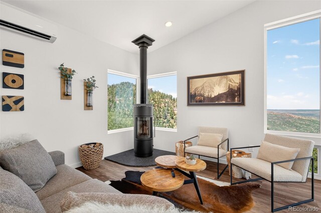 555 Sunrise Peak Rd, Manitou Springs, CO 80829 - living room featuring a wall mounted AC, wood finished floors, plenty of natural light, and recessed lighting