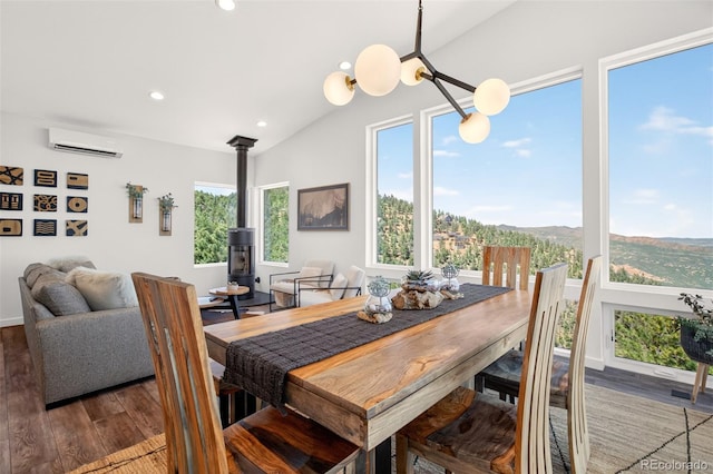 555 Sunrise Peak Rd, Manitou Springs, CO 80829 - dining room featuring a wall mounted AC, a wood stove, wood finished floors, vaulted ceiling, and recessed lighting