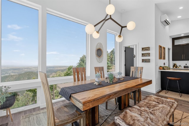 555 Sunrise Peak Rd, Manitou Springs, CO 80829 - dining room with wood finished floors, a wall unit AC, and a high ceiling