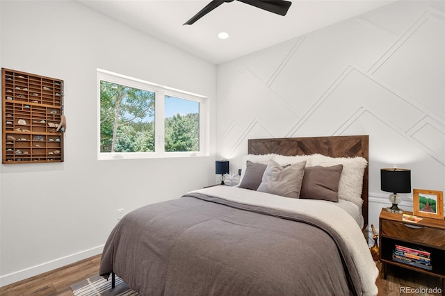 555 Sunrise Peak Rd, Manitou Springs, CO 80829 - bedroom featuring wood finished floors, a decorative wall, and ceiling fan