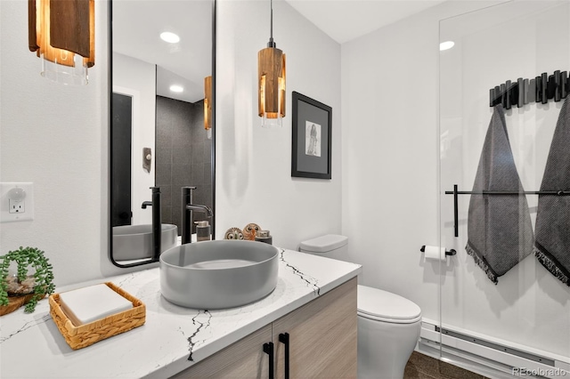 555 Sunrise Peak Rd, Manitou Springs, CO 80829 - bathroom featuring a baseboard heating unit, vanity, and a shower
