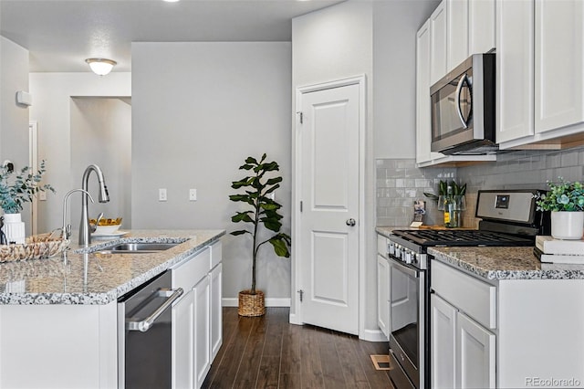 3548 Swabuck Pl, Castle Rock, CO 80109 - kitchen with stainless steel appliances, a sink, dark wood-type flooring, decorative backsplash, and light stone countertops