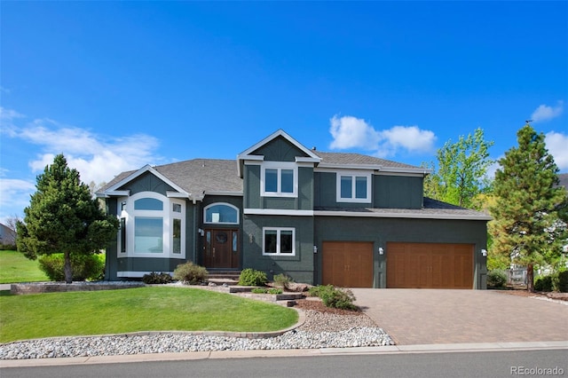 25 Sand Cherry, Littleton, CO 80127 - view of front of home with a front lawn, driveway, and an attached garage