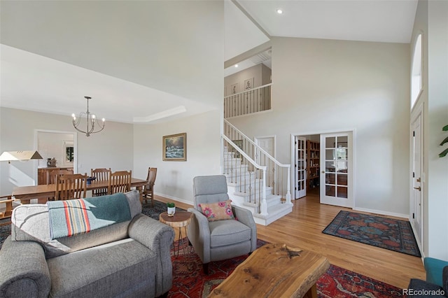25 Sand Cherry, Littleton, CO 80127 - living room featuring a chandelier, wood finished floors, stairway, high vaulted ceiling, and french doors