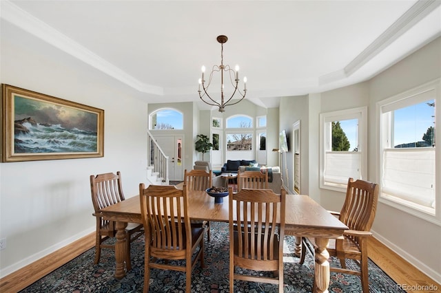 25 Sand Cherry, Littleton, CO 80127 - dining room with a chandelier, light wood-style flooring, a raised ceiling, stairway, and crown molding