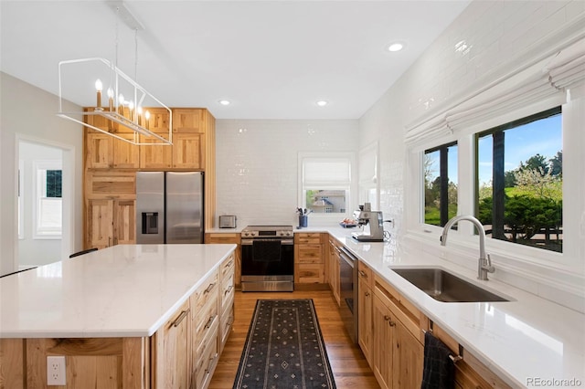 25 Sand Cherry, Littleton, CO 80127 - kitchen with appliances with stainless steel finishes, light wood finished floors, a chandelier, recessed lighting, and hanging light fixtures