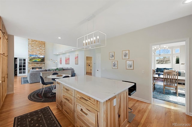 25 Sand Cherry, Littleton, CO 80127 - kitchen with a chandelier, light wood finished floors, light brown cabinetry, a center island, and recessed lighting