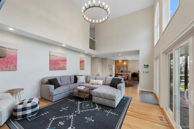 25 Sand Cherry, Littleton, CO 80127 - living room with wood finished floors, a high ceiling, and a chandelier