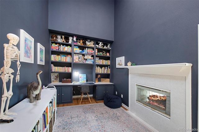 25 Sand Cherry, Littleton, CO 80127 - office area featuring wood finished floors, a tiled fireplace, and built in desk