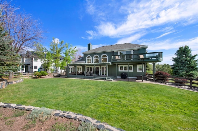 25 Sand Cherry, Littleton, CO 80127 - back of house featuring a patio, a deck, and a chimney