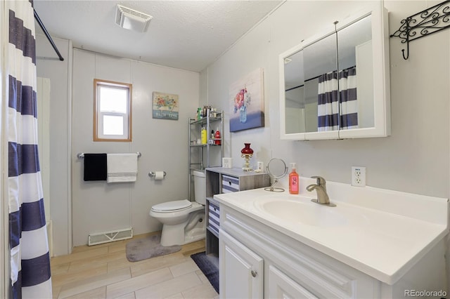 bathroom featuring toilet, vanity, a textured ceiling, and a shower with curtain