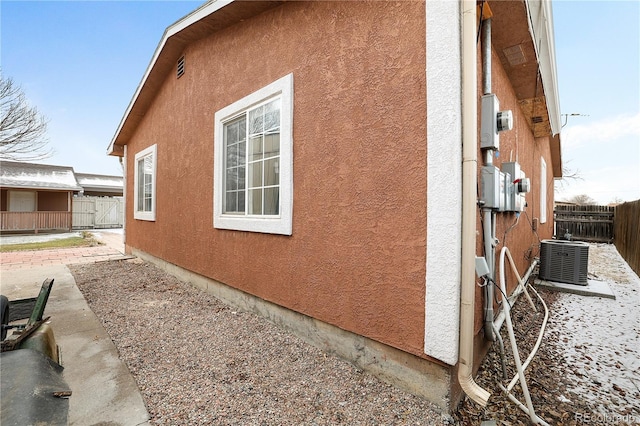 view of home's exterior with cooling unit and a patio