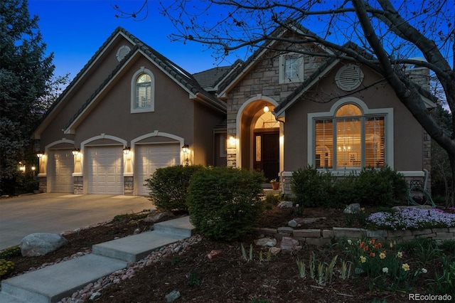 craftsman inspired home featuring stucco siding, driveway, and stone siding