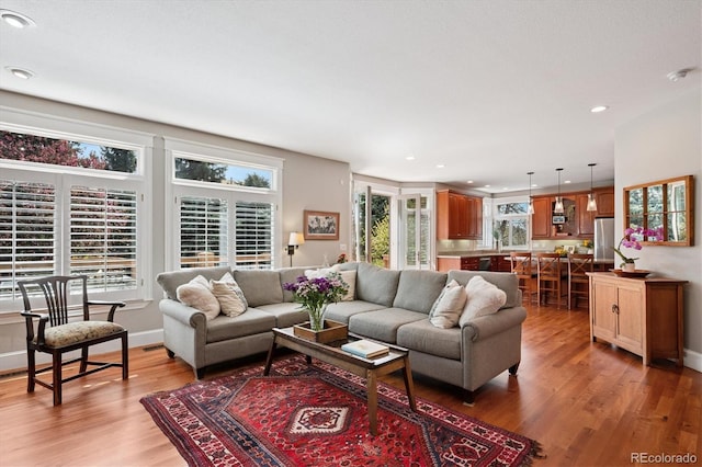 living room featuring light wood-type flooring and recessed lighting