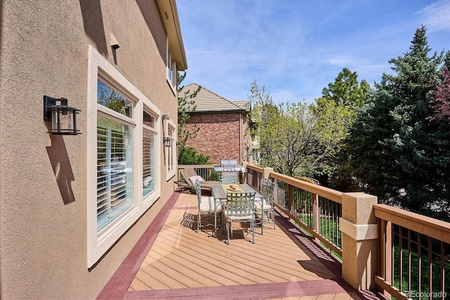 wooden deck featuring a grill