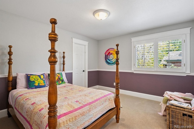 bedroom with carpet flooring and baseboards