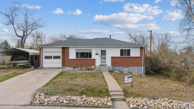 view of front facade featuring roof with shingles, concrete driveway, brick siding, a detached carport, and a garage