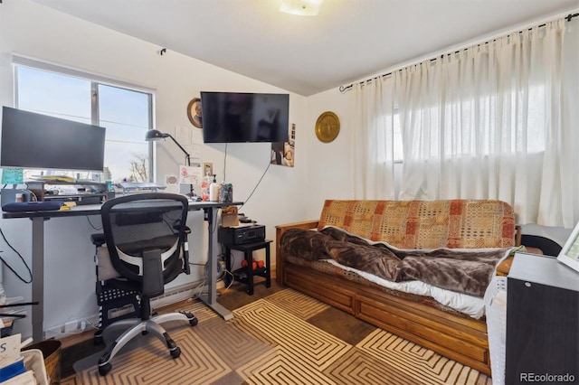 home office featuring lofted ceiling and a healthy amount of sunlight