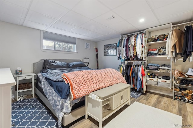 bedroom featuring a paneled ceiling, visible vents, and wood finished floors