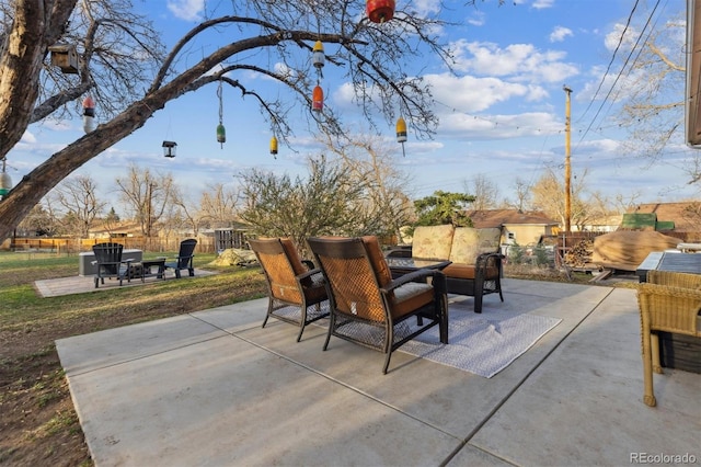 view of patio / terrace featuring an outdoor living space and fence