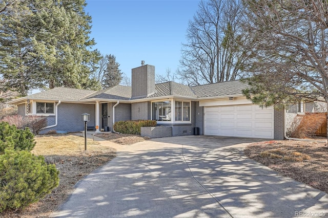 single story home featuring brick siding, driveway, a chimney, and a garage