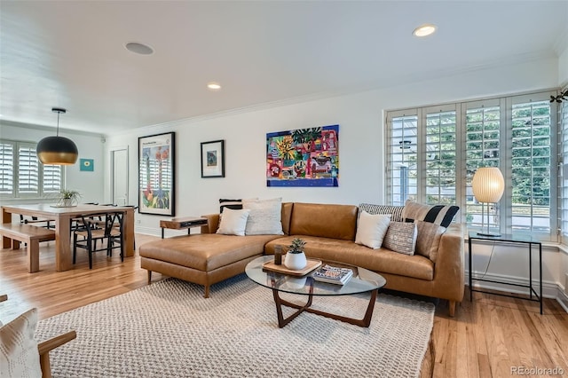 living room featuring recessed lighting, light wood-style floors, baseboards, and ornamental molding