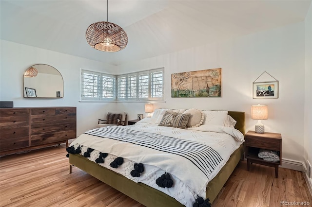 bedroom featuring vaulted ceiling, baseboards, and wood finished floors