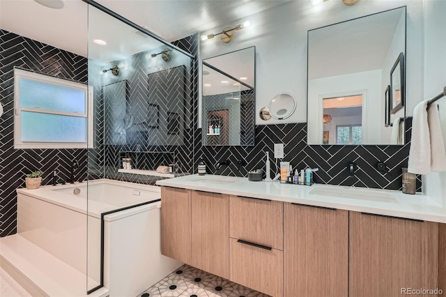 bathroom with a sink, tile walls, double vanity, and a shower stall