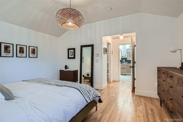 bedroom with baseboards, light wood-type flooring, and lofted ceiling