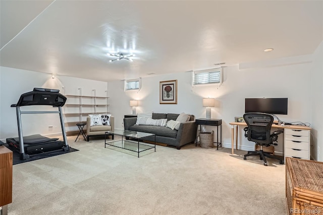 carpeted living area with visible vents and baseboards