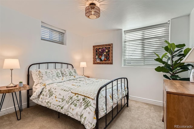 bedroom featuring baseboards and light carpet