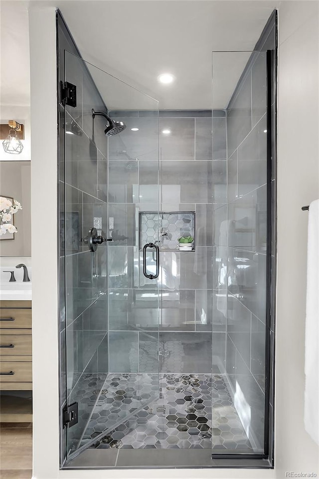 bathroom with an enclosed shower and vanity