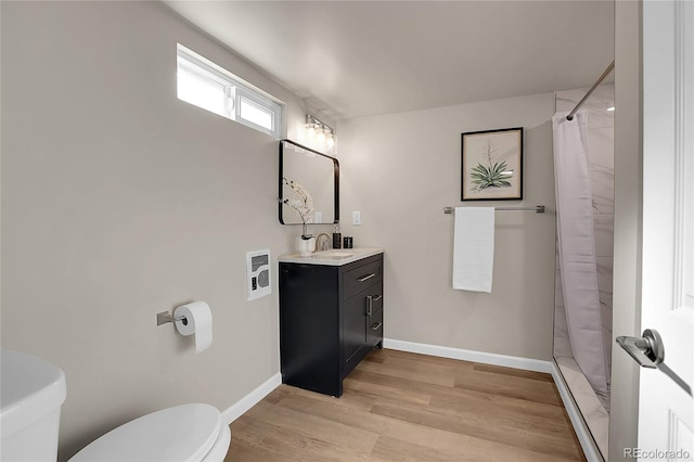 bathroom with toilet, vanity, a shower with curtain, and hardwood / wood-style flooring