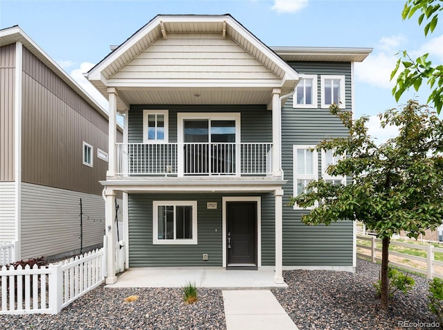 17767 E 54th Ave, Denver, CO 80249 - view of front facade featuring a balcony, fence, and a porch