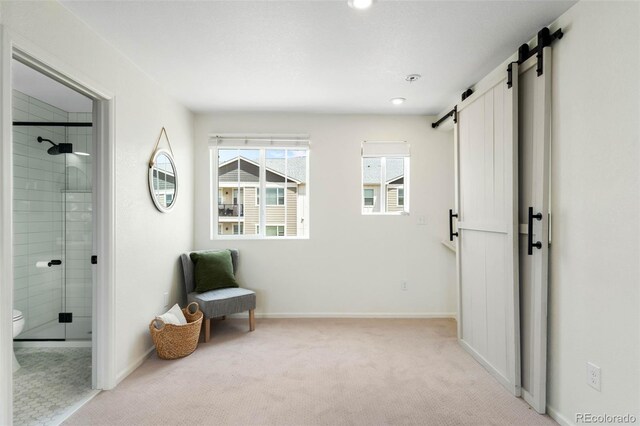 17767 E 54th Ave, Denver, CO 80249 - living area featuring a barn door, light carpet, baseboards, and recessed lighting