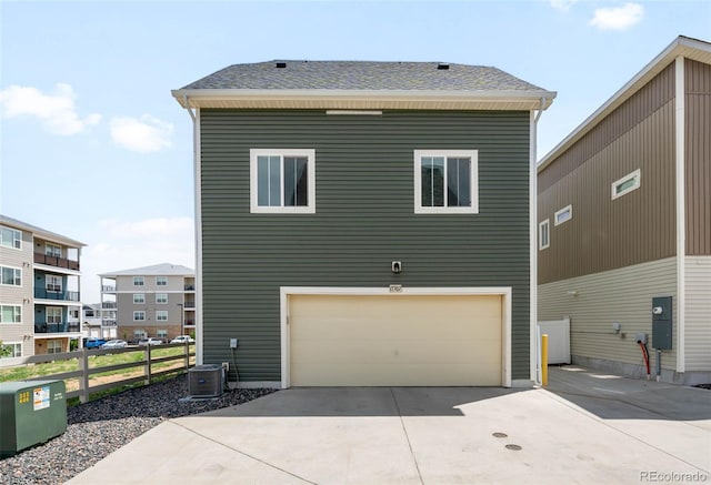17767 E 54th Ave, Denver, CO 80249 - back of house with fence, driveway, a garage, and central AC