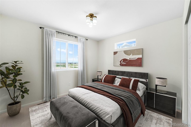 17767 E 54th Ave, Denver, CO 80249 - bedroom featuring carpet flooring, multiple windows, and baseboards