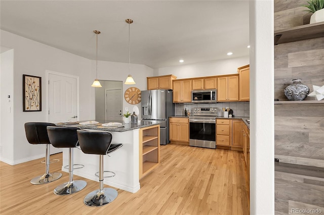 3406 Purcell St, Brighton, CO 80601 - kitchen with stainless steel appliances, open shelves, light wood-style flooring, recessed lighting, and a kitchen breakfast bar