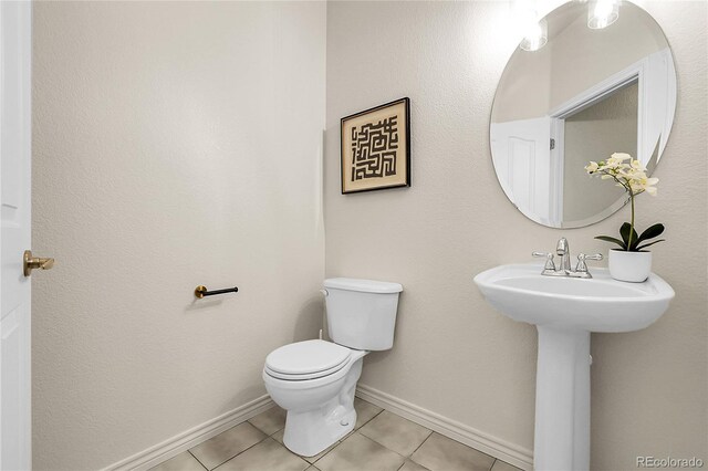 3406 Purcell St, Brighton, CO 80601 - half bath with toilet, tile patterned flooring, and baseboards