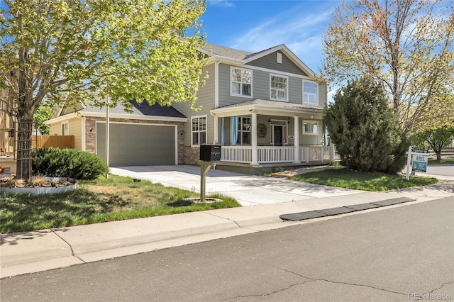 3406 Purcell St, Brighton, CO 80601 - view of front of property featuring a porch, concrete driveway, stone siding, and a garage