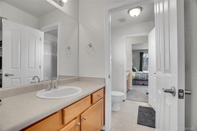 3406 Purcell St, Brighton, CO 80601 - ensuite bathroom with tile patterned flooring, toilet, and vanity