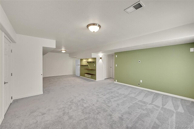 3406 Purcell St, Brighton, CO 80601 - finished below grade area featuring light carpet, baseboards, and a textured ceiling