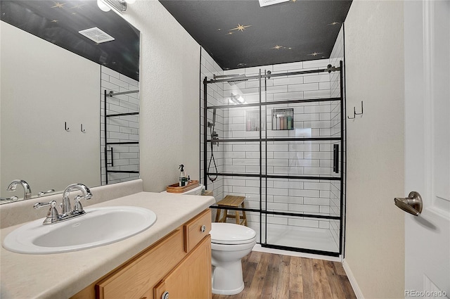 3406 Purcell St, Brighton, CO 80601 - full bathroom featuring wood finished floors, toilet, a shower stall, and vanity
