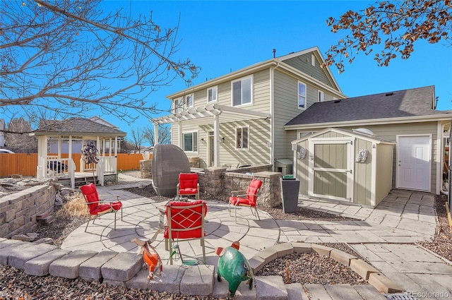 3406 Purcell St, Brighton, CO 80601 - rear view of house with a gazebo, a shed, a patio area, and fence