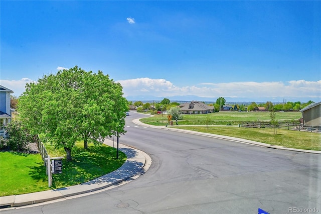 3406 Purcell St, Brighton, CO 80601 - view of asphalt road with curbs and traffic signs
