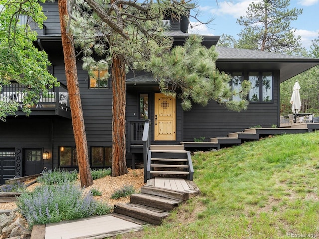 28833 Western Dr, Evergreen, CO 80439 - view of front of house featuring a front lawn and a shingled roof