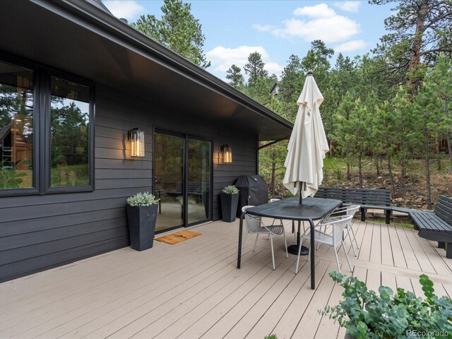 28833 Western Dr, Evergreen, CO 80439 - wooden terrace featuring outdoor dining space and area for grilling