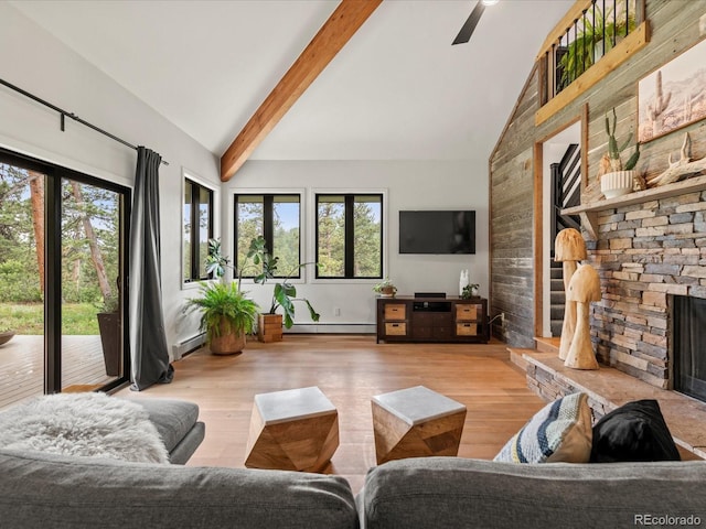 28833 Western Dr, Evergreen, CO 80439 - living area featuring wood finished floors, a baseboard heating unit, beamed ceiling, a stone fireplace, and high vaulted ceiling