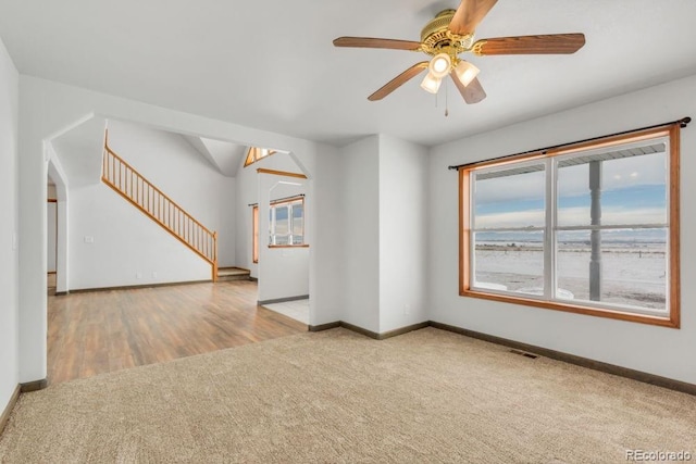 carpeted empty room featuring ceiling fan